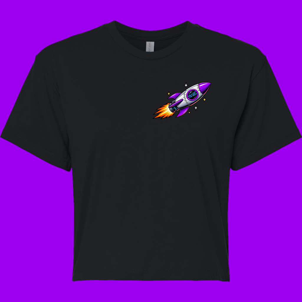 Black t-shirt featuring a purple and silver rocket graphic on the chest with orange flame trails and stars around it, on a purple background.